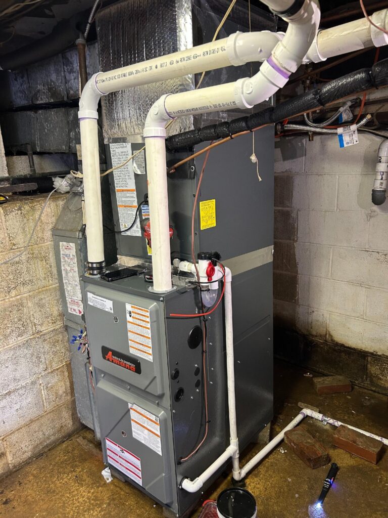 Moon Air technician servicing HVAC unit outdoors, tools and gauges attached