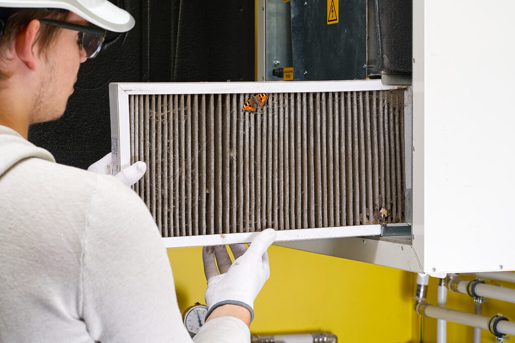 Moon Air technician installing a scaled air purifier during service visit